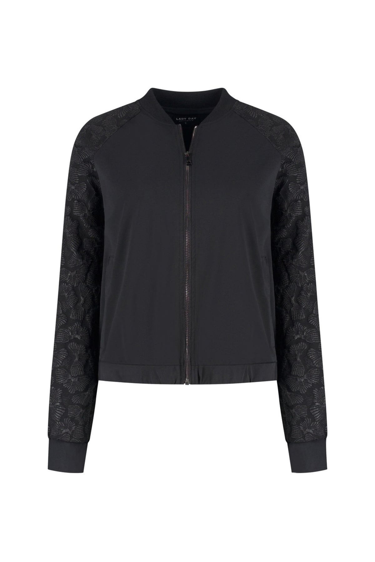 Lady Day reissjajacke Jaymi in zwart, lichtgewicht en waterbestendig, geschikt voor reizen en buitenactiviteiten.