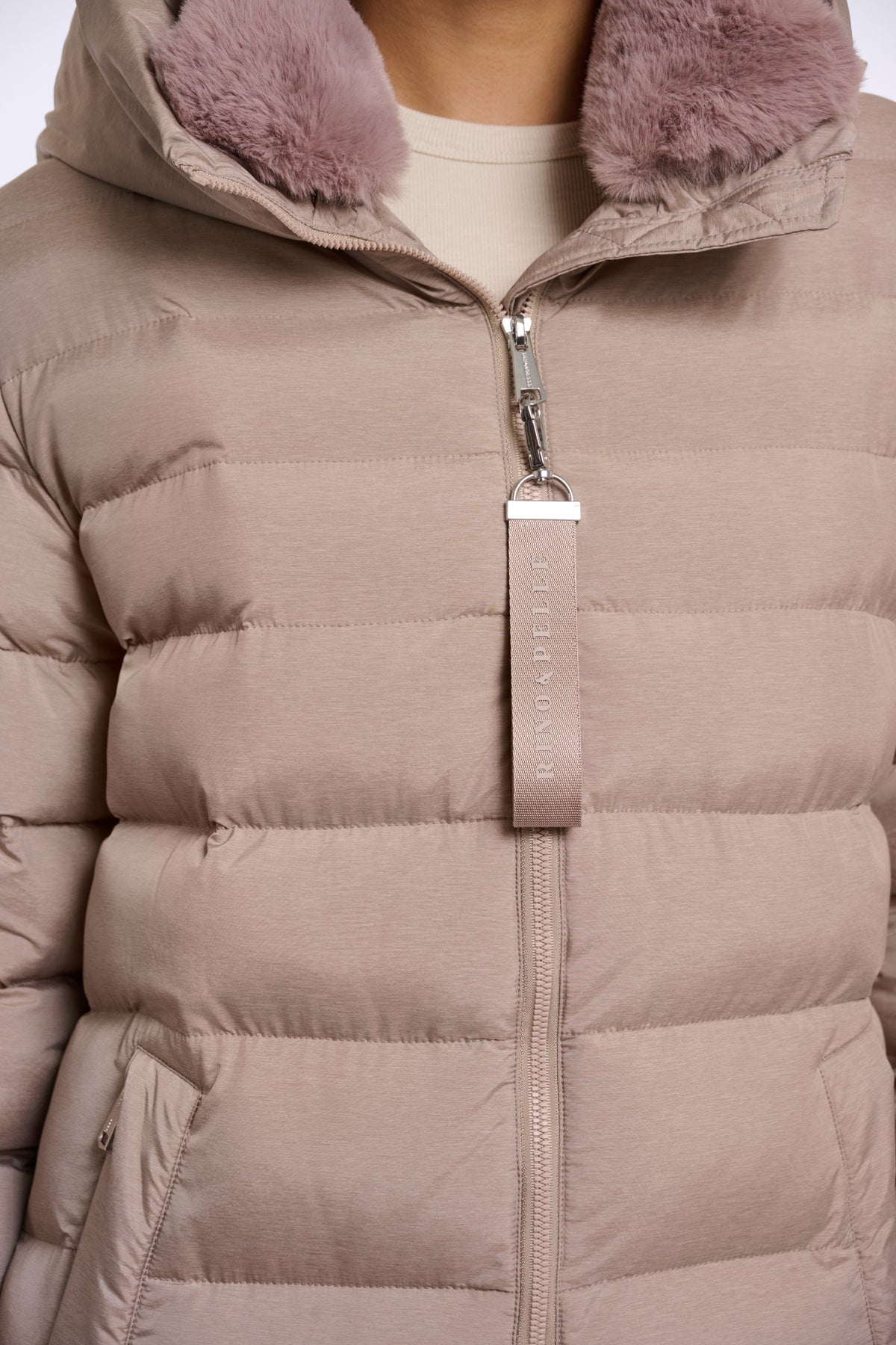 Lichte mocha latte Rino & Pelle Hudson jas voor dames, zichtbaar in de afbeelding, met capuchon en modieuze pasvorm.