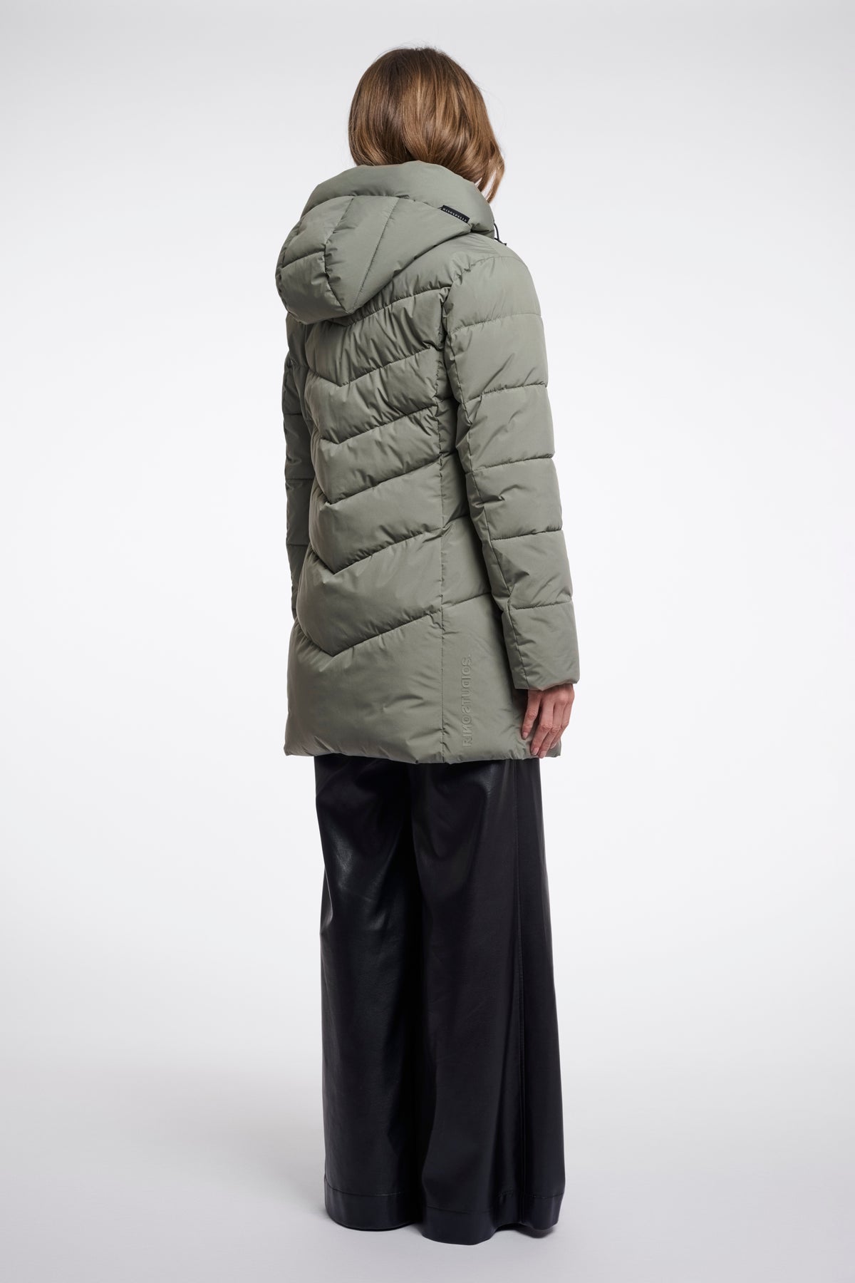 Lichtblauwe Yasmina jas van Rino & Pelle met capuchon en knopen, gedragen door model op witte achtergrond.