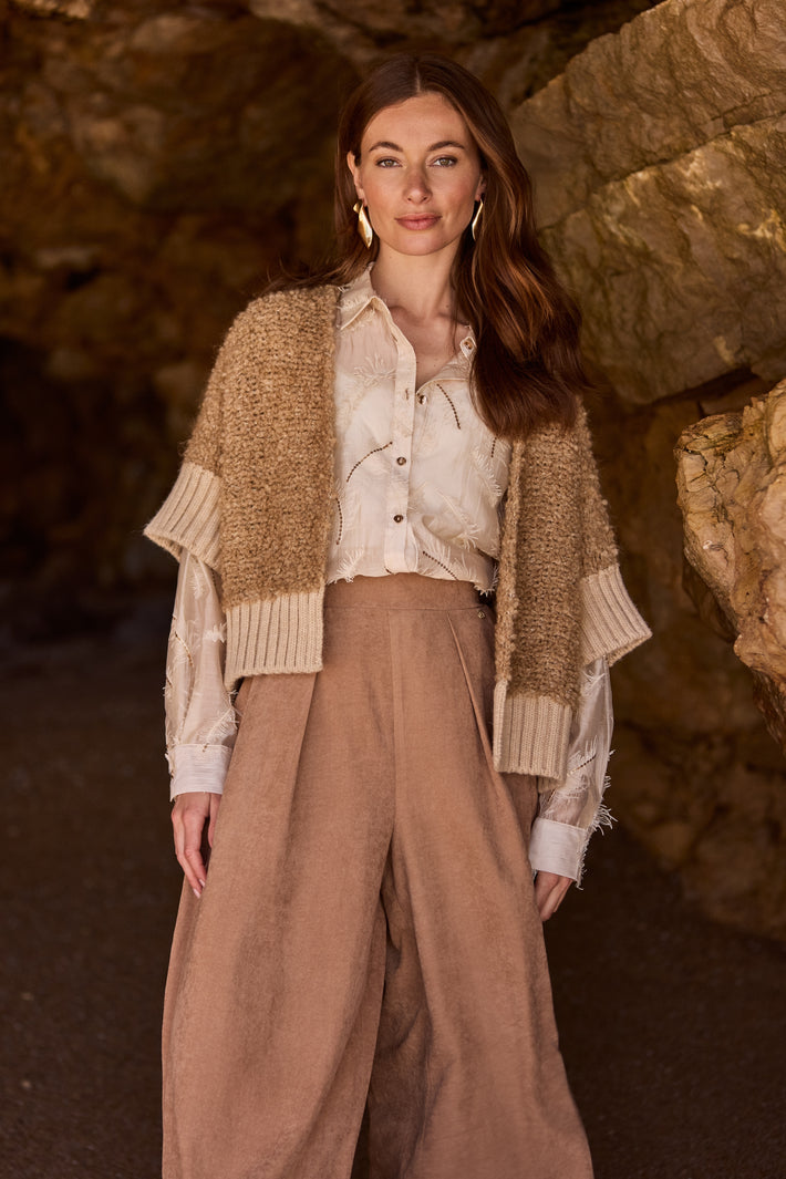 Blouse Aysha met veren in zandkleur van Nukus, elegante damesblouse met decoratieve veren en zachte stof.