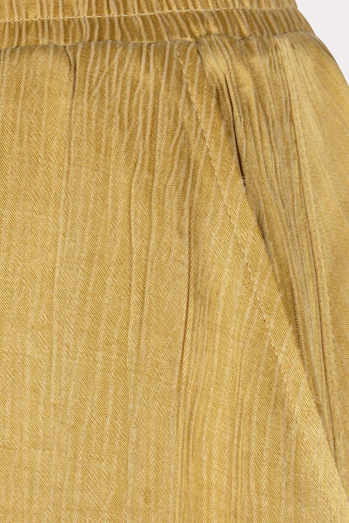 Lange crinkle rok van EsQualo in gouden olijftinten met elegante uitstraling en vloeiende textuur, gedragen door een model.