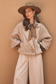 Nukus Danique Pearls Sand jas met stijlvolle details, korte pasvorm en lichte zandkleur, modieus voor winter en herfst.