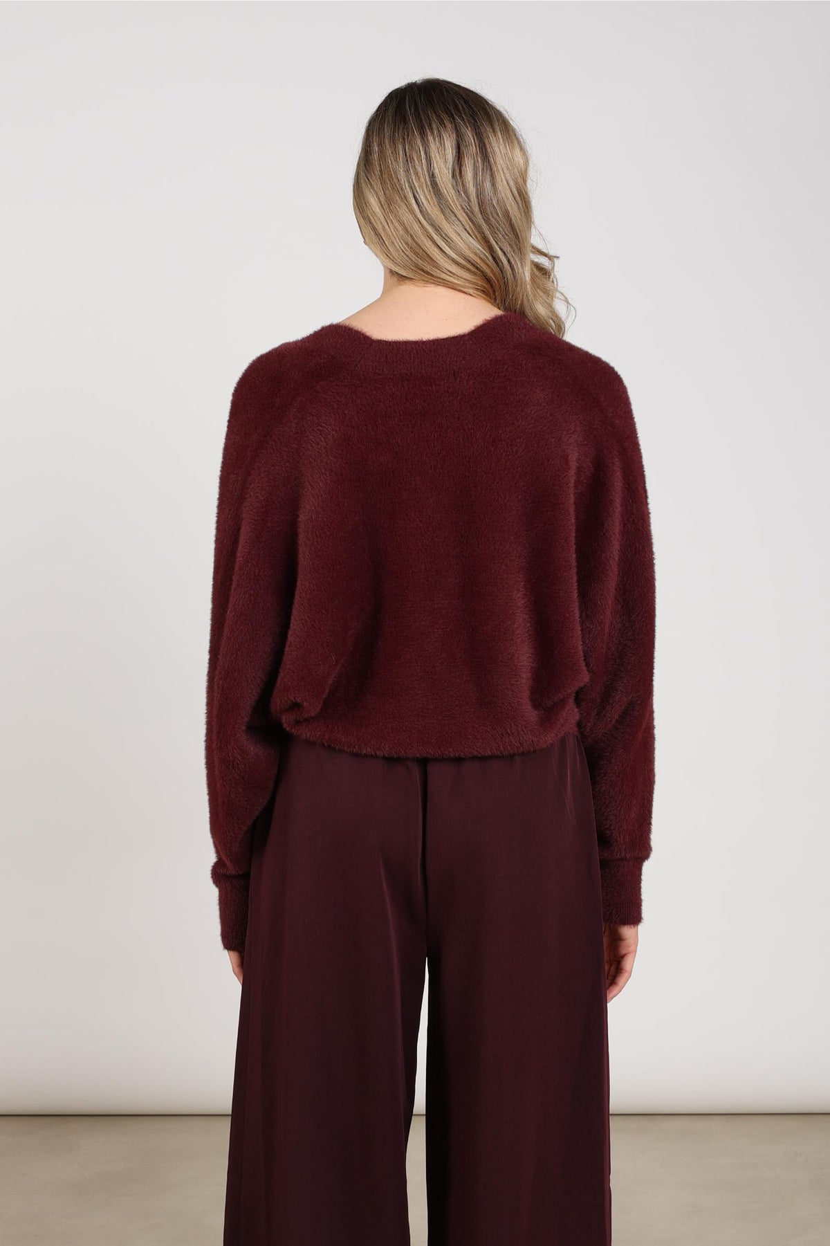 Donkerrode Nukus Trui Beau Wrap Cherry met zachte stof en stijlvolle pasvorm, zichtbaar in de afbeelding.