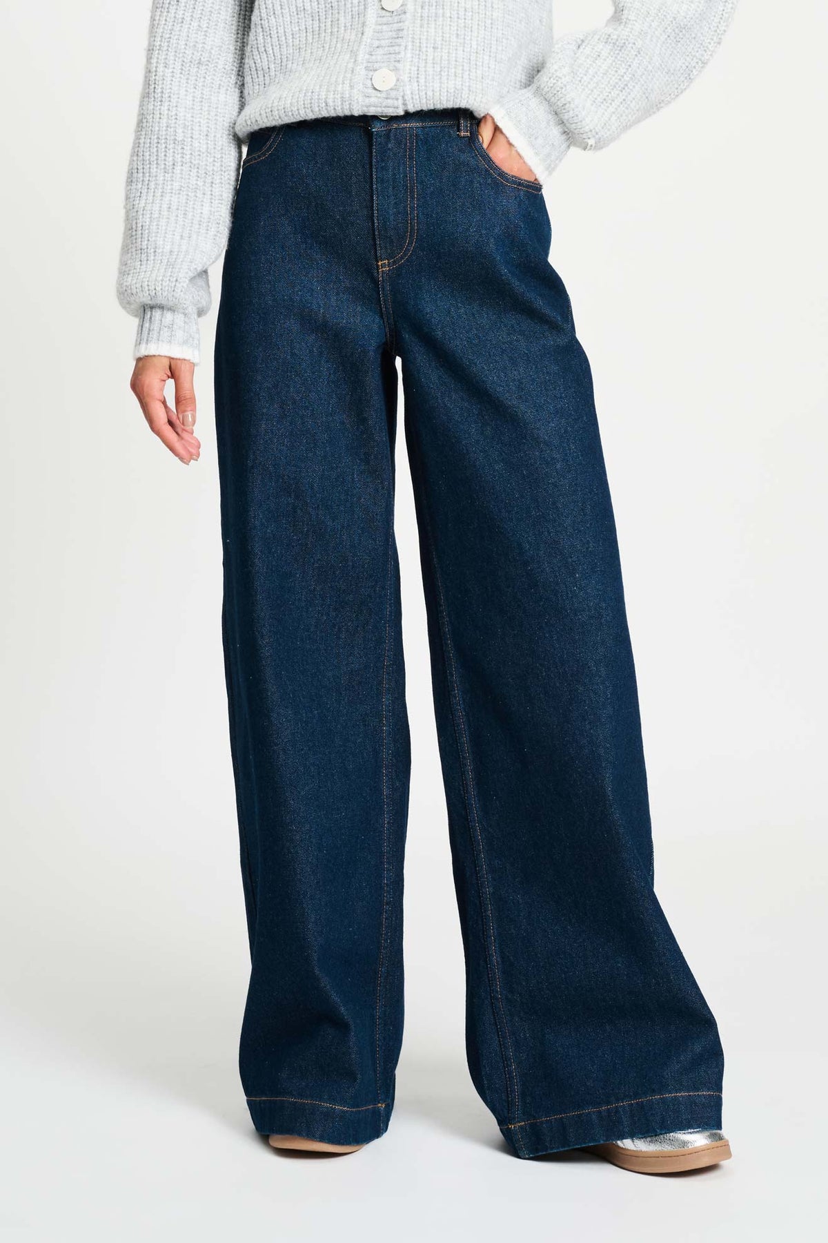 Donkere blauwe POM Amsterdam Jamy baggy wijde jeans met losse pasvorm en lichte wassing, gedragen door een model.