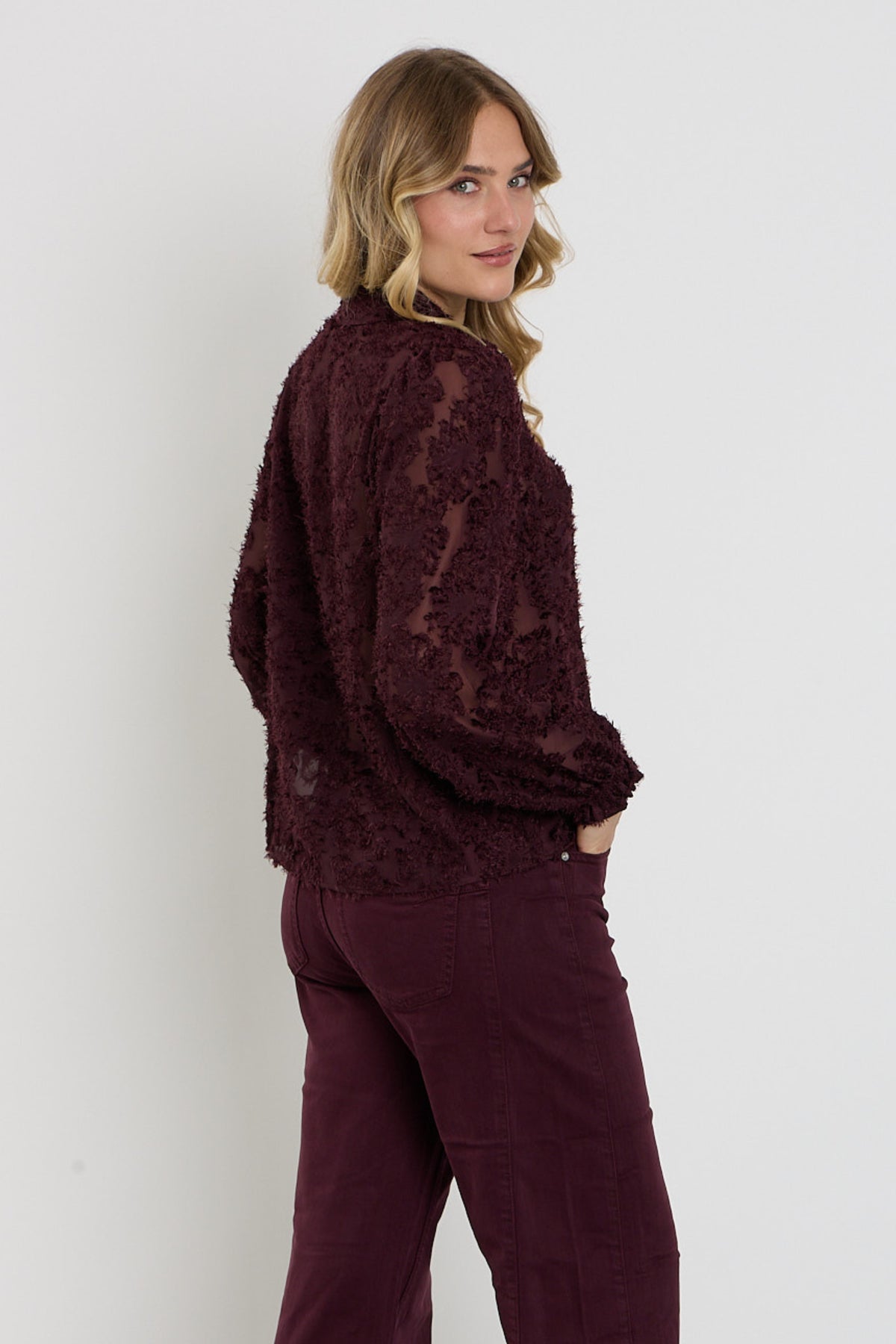 Bourgondische rode blouse met franjes van Red Button, close-up van de stof en details van de blouse.