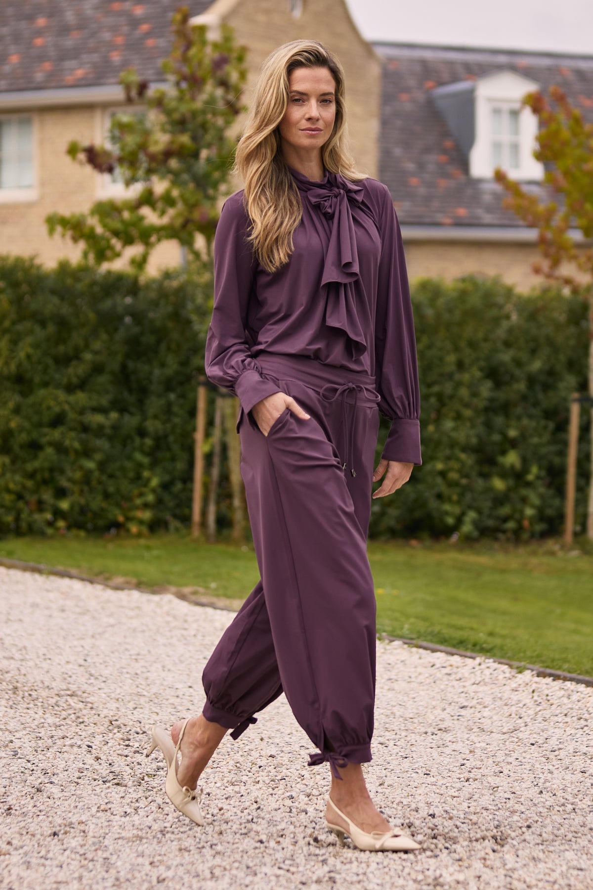 Mi Piace Travel blouse met strik in plumkleurige stof, stijlvolle en comfortabele damesblouse voor reizen en casual dagen.