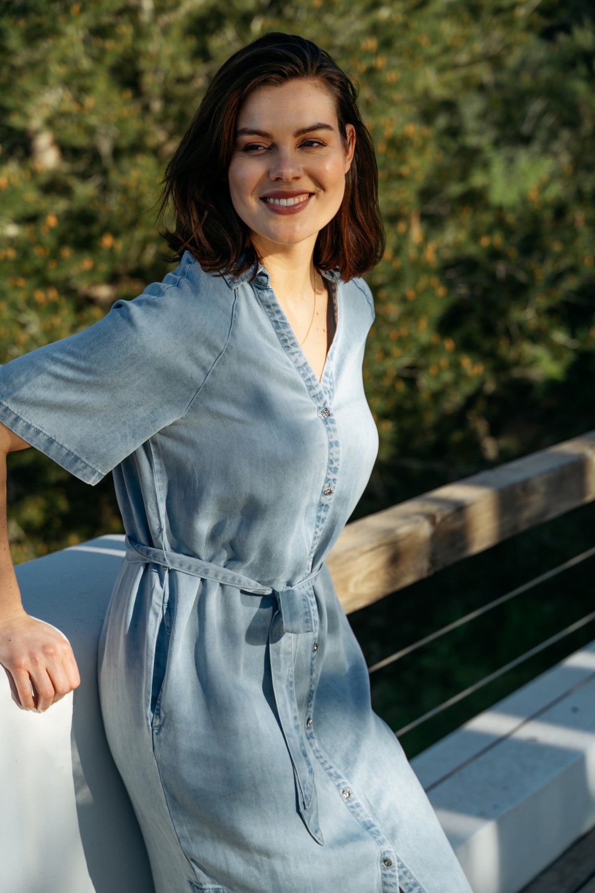 Lichte denim jurk Jacklyn Light Denim van &Co woman, model met lange mouwen en knopen, gedragen door een model op een witte achtergrond.