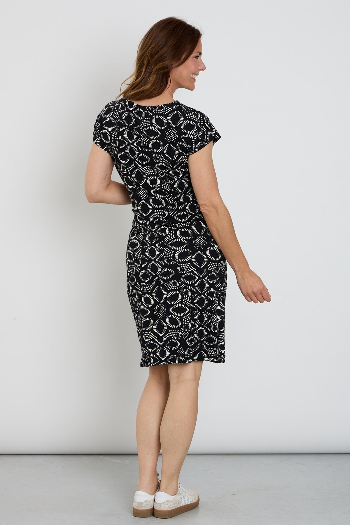 Zoso Eliza Black jurk met vloeiende stof en elegante snit, gedragen door een model, op een lichte achtergrond.