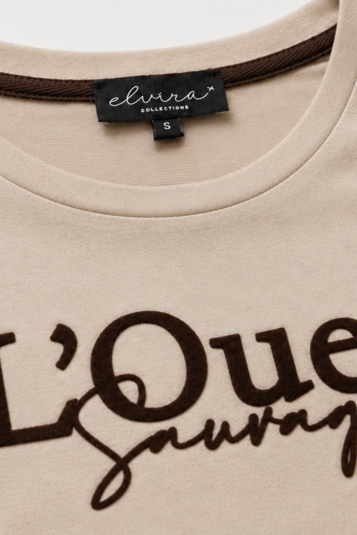 L'Quest Warm ivoor T-shirt van Elvira Casuals, casual katoen met ronde hals en korte mouwen, gedragen door een model.