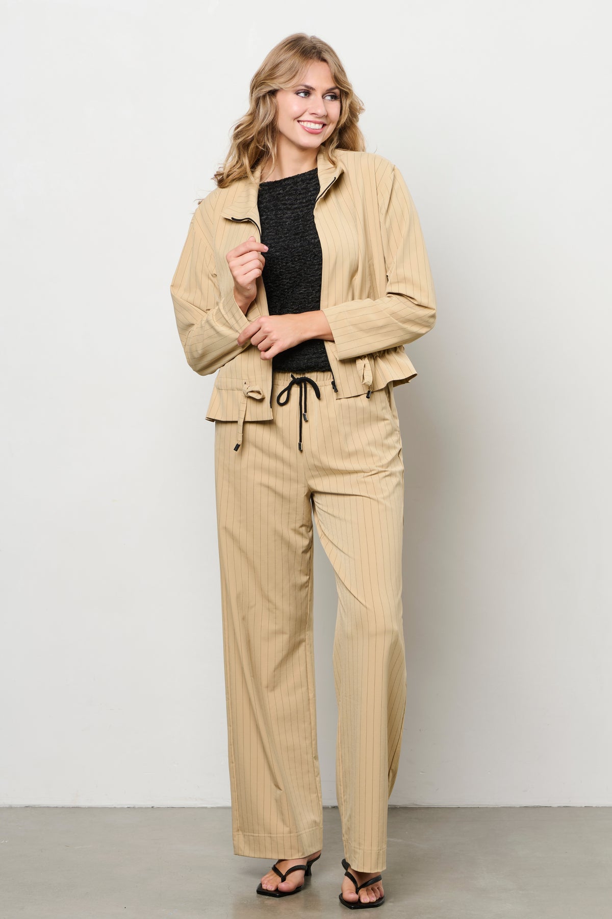 Lange reisbroek van &Co woman met stripe patroon in sunset kleuren, comfortabel en stijlvol voor reizen en dagelijks gebruik.