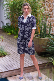 Lichte reisjurk van Mi Piace met polokraag en strikprint in navy en offwhite, geschikt voor casual en vakantiedagen.