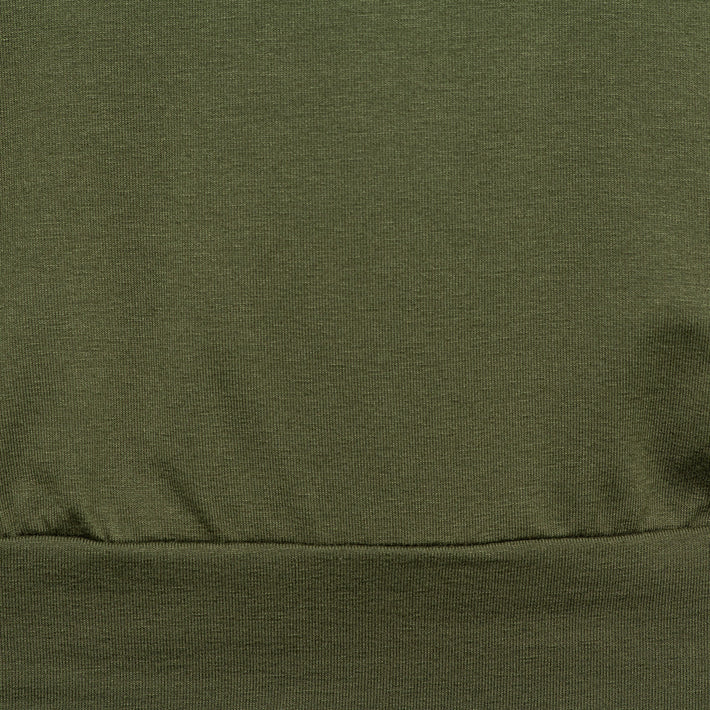 Luchtige groene top Lucille Olive van &Co woman, met korte mouwen en ronde hals, gedragen door een model.