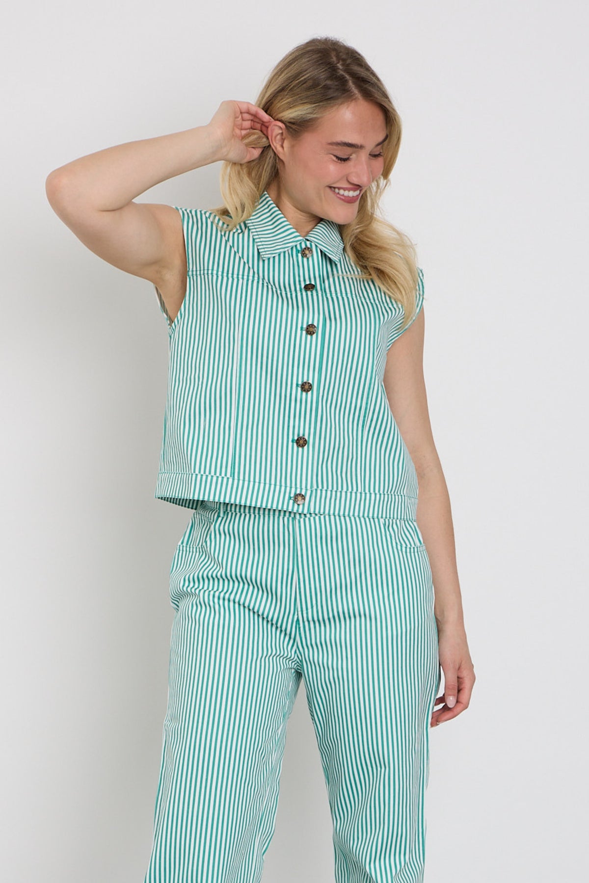 Groene Ydence Gilet Marit met zachte stof en ritssluiting, gedragen door een persoon in een rustige buitenomgeving.